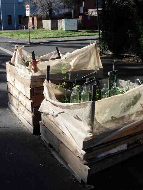 Simple - a few pallets nailed together, a sheet of weed barrier, some dirt and voila! Portable community garden. 
